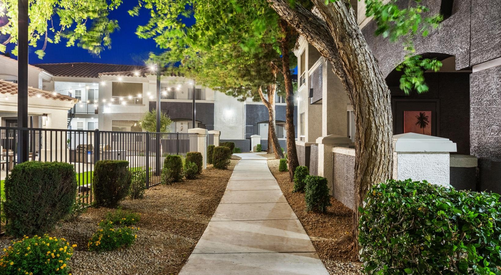 The essence of exceptional living a sidewalk with trees and bushes