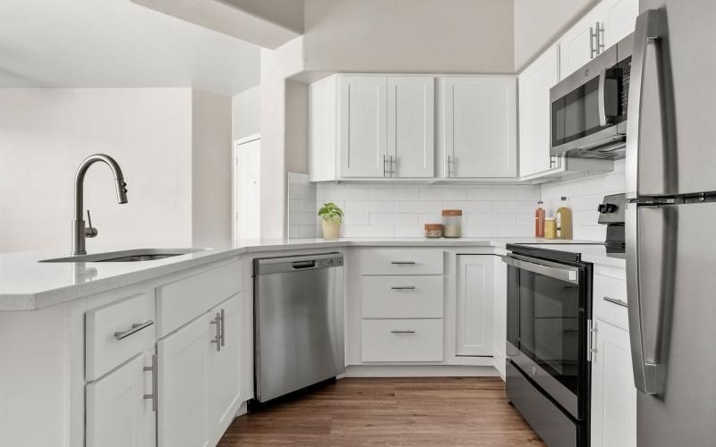 a kitchen with white cabinets