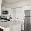 kitchen with white cabinets and bar stools