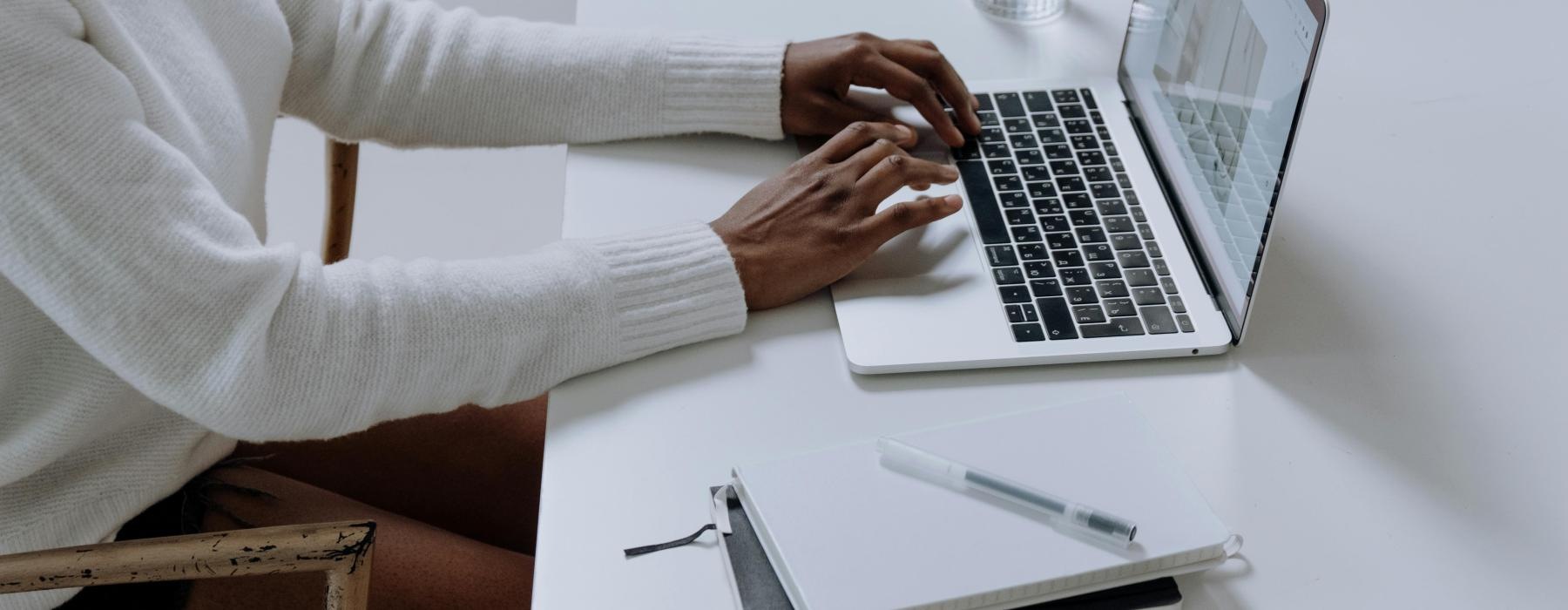 a man and a woman working on a laptop