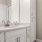 a bathroom with white cabinets