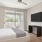 a bedroom with a bed and a television