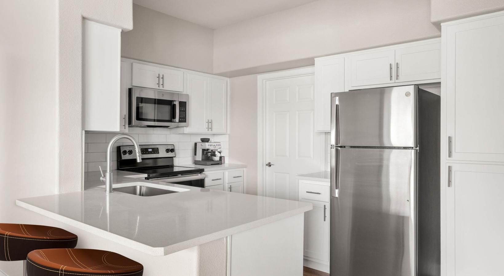 Spacious kitchens with thoughtful details a kitchen with white cabinets