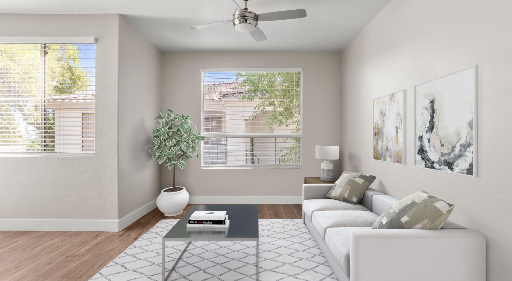 Wide open living areas perfect for entertaining a living room with a white couch and a table with a plant