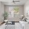 a living room with a white couch and a table with a plant