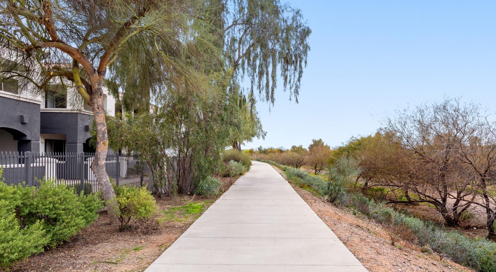 Settle into comfort at Sierra Canyon a walkway with trees around it
